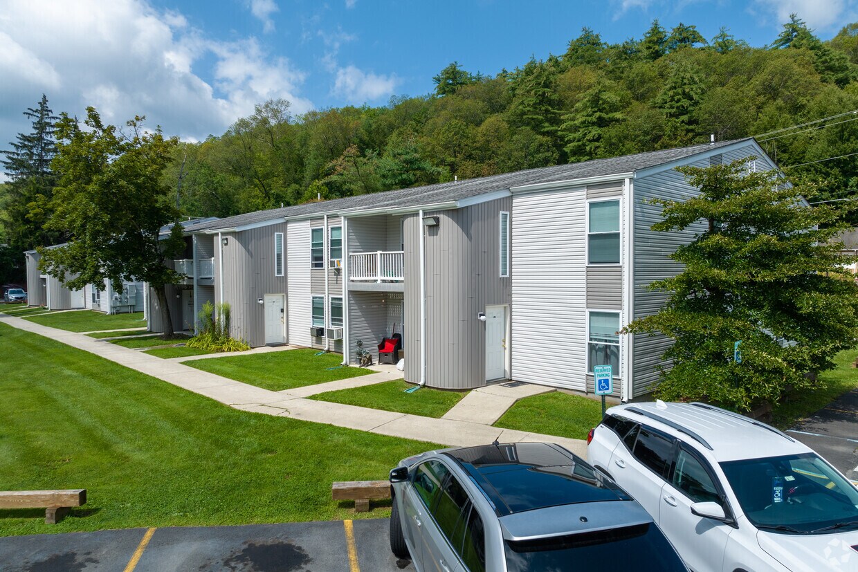 Apartment building exterior and resident parking at Emerald Pond Estates